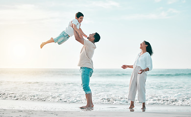 Image showing Family, beach and father lifting boy child with love, freedom and travel celebration in nature. Flying, fun and parents with kid at the ocean for bond, happy and airplane game while traveling in Bali