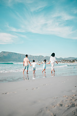 Image showing Family is walking on beach, hand holding and back view, ocean and bonding on holiday, freedom and travel. Parents, young children and solidarity on tropical vacation in Mexico, love and care outdoor