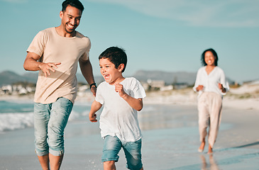 Image showing Family, father and son running on beach with mother, ocean and energy with bonding on holiday, happiness and freedom. Parents, boy and carefree on tropical vacation in Mexico, love and care outdoor