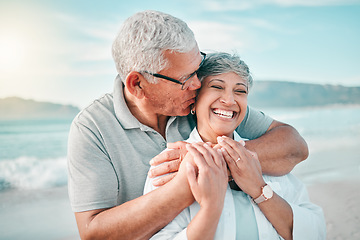 Image showing Happy, kiss or old couple laughing on beach with love, care or support on summer vacation in nature. Retirement, mature man hugging or funny senior woman at sea or ocean to travel on holiday together