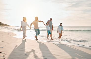 Image showing Holding hands, swing and big family at the beach walking with freedom, travel and bonding at sunset. Love, lifting and and boy child with grandparents and parents at sea on walk for summer holiday