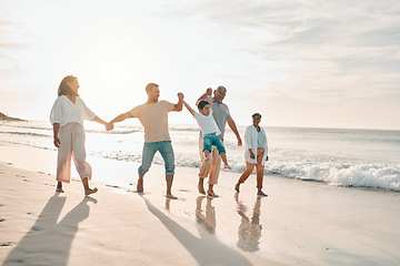 Image showing Holding hands, big family and swing at the beach walking with freedom, travel and bonding at sunset. Love, lifting and and boy child with grandparents and parents at sea on walk for summer holiday