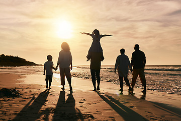 Image showing Silhouette, family is walking on beach and back view with ocean waves, sunset and bonding in nature. Generations, people outdoor and tropical holiday, freedom and travel with trust and love in Mexico