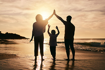 Image showing Silhouette, family and protection, beach at sunset with parents and child, safety and ocean waves. Bonding in nature, insurance and people outdoor, tropical holiday and travel with trust and love