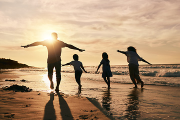 Image showing Silhouette, family is running on beach and back view with ocean waves, sunset and bonding in nature. Energy, action people outdoor on tropical holiday and freedom, travel with trust and love