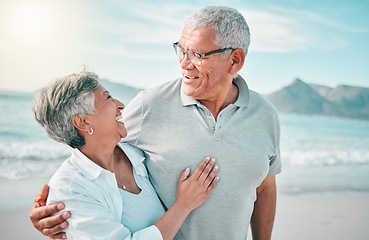 Image showing Happy, hug or old couple laughing on beach with love, care or support on summer vacation in nature. Retirement, mature man talking or funny senior woman at sea or ocean to travel on holiday together