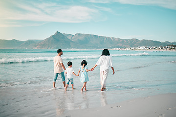 Image showing Family walk on a beach, holding hands and bonding in nature, back view with ocean waves and summer in Mexico. Parents, kids and people outdoor on holiday, freedom and travel with trust and love