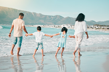 Image showing Hand holding, family is walking on beach and back view with ocean waves, summer and bonding in nature. Parents, children and people outdoor on holiday, freedom and travel, trust and love in Mexico