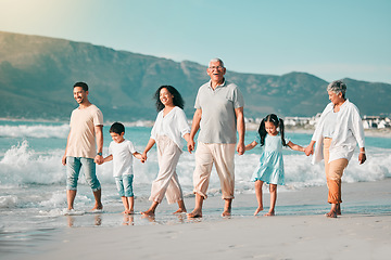 Image showing Holding hands, family is walking on beach and ocean, generations and bonding in nature with waves. Grandparents, parents and kids, people outdoor and travel with trust and love on Mexican holiday