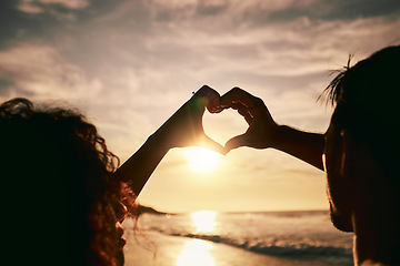 Image showing People with heart hands, sunset on beach, silhouette with love and romance sign, travel and outdoor. Adventure, emoji and care with health in nature, support and commitment, couple with trust and sea