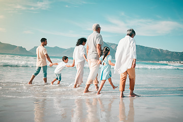 Image showing Holding hands, family is walking on beach with ocean and back view, solidarity and bonding in nature. Generations, people outdoor on tropical holiday and freedom, travel with trust and love in Mexico