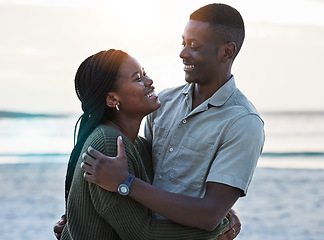 Image showing Black couple, hug and happy outdoor at the beach with love, care and commitment. Smile on face of young african man and woman together on vacation, holiday or sunset travel adventure in Jamaica