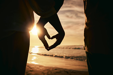 Image showing Silhouette, hands and heart, sunset on beach and solidarity with love and care, support and people together outdoor. Ocean, tropical holiday and nature, travel and calm with trust and adventure