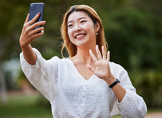 Image showing Happy, woman and wave hello to phone for video call, blog or social media, communication or post on internet in the park. Selfie, face and girl with a smile for smartphone conversation or film