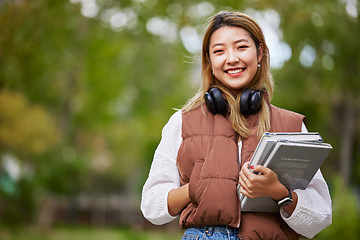 Image showing Student with headphones, portrait and woman with books for learning, education and on university campus with happiness or pride. Happy, face and girl in college with notebook or walking to class