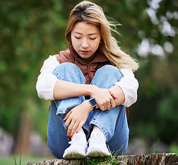 Image showing Student, sad and thinking with woman in park for depression, college and anxiety. Mental health, psychology and burnout with Asian person feeling lonely in nature for fatigue, pain and grief