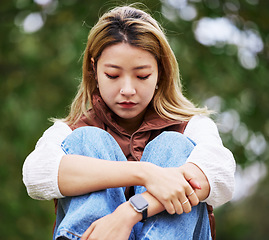 Image showing Student, depression and thinking with woman in park for sad, college and anxiety. Mental health, psychology and burnout with asian person feeling lonely in nature for fatigue, pain and problem