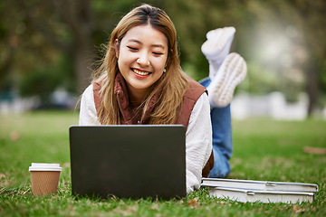 Image showing Laptop, asian and woman student typing in a park to update social media while outdoor studying and learning online. Internet, web and young person working on assessment in nature for peace and calm