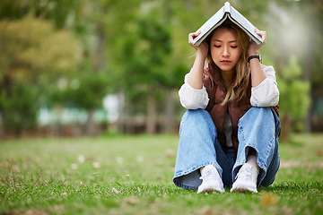 Image showing Study, sad and book with woman in park for studying, thinking or depression mockup. College, mental health and education with asian student on grass in nature for burnout, anxiety and fatigue problem