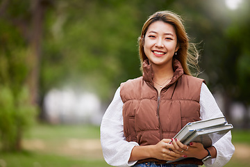 Image showing Asian student, portrait and woman with books for learning, education and outdoor on university campus with happiness or pride. Happy, face and girl in college with notebook or walking to class