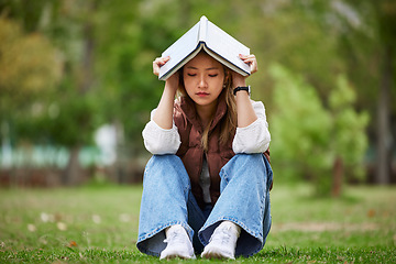 Image showing Study, stress and book with woman in park for studying, thinking and depression. College, mental health and education with asian student on grass in nature for burnout, anxiety and fatigue problem