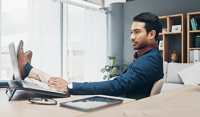 Image showing Relax business man with his feet up on desk working on laptop for job confidence, productivity and successful career. Serious Asian CEO, boss or professional person relaxing in office on computer