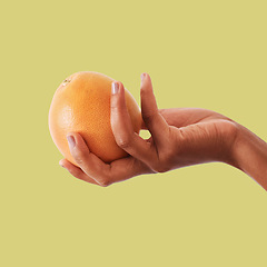 Image showing Hands, orange and fruit for vitamin C, healthy diet plan or nutrition against a studio background. Hand holding fruity food, nectarine or grapefruit for health, organic wellness or citrus on mockup