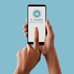 Image showing Hands, phone and mockup screen for healthcare, Telehealth or medical care against a blue studio background. Hand touching smartphone display for online health advice, mobile app or communication