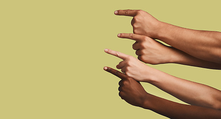 Image showing Mockup, hands and group of people in studio with answer, gesture or sign against yellow background. Finger, direction and emoji hand showing solution, faq or about us, vote or opinion while isolated