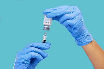 Image showing Mockup, closeup and hands with needle, vial and vaccination for diagnosis against a blue studio background. Zoom, hands and gloves, with medicine, cure and vaccination for medical diagnosis or result
