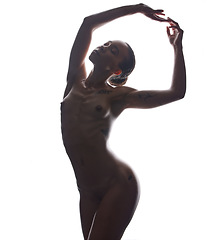 Image showing Nude pose, sexy woman and beauty of body for art and creative erotic nudity in a studio. White background, isolated silhouette and young female model naked feeling seductive and sensual in shadow