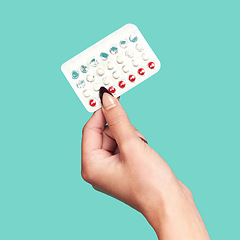 Image showing Woman hands, tablets and medication for birth control on mockup against a studio background. Hand of female holding contraception, healthcare product or medical prescription for market advertising