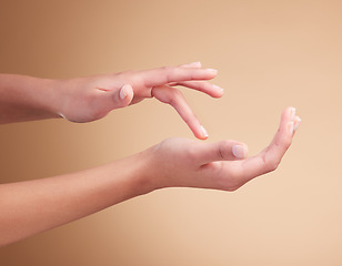 Image showing Hands, manicure and palm beauty of female model with cosmetic care, skincare or self care isolated in brown studio background. Polish, shine and nails with natural glow and healthy skin