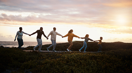 Image showing Family holding hands and walking in nature for group support, growth development and adventure together in sunset. Children with grandparents for fitness, health and running by a park path or ocean