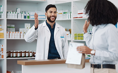 Image showing Customer service, counter and pharmacist man with medicine, expert advice or healthcare support. Happy doctor, medical professional or friendly retail person in pharmacy talking to woman at help desk