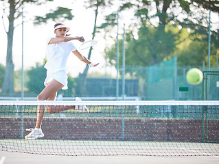 Image showing Tennis, outdoor match and woman hit a sports ball with a racket service on a exercise court. Sport game, workout competition and young female doing cardio action for wellness and health in summer