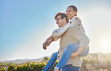 Image showing Couple, interracial and love with adventure outdoor, piggyback and smile while on holiday with summer and sun. Relationship, commitment and care with man and black woman, happy with peace and travel.