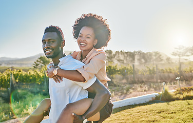 Image showing Black couple, piggy back or bonding in park, nature garden or sustainability environment in fun activity game or love. Smile, happy man or afro woman in carry support, trust or freedom playful date