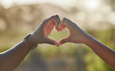 Image showing Heart, love hands and black couple in nature on holiday, trip or vacation. Romance, affection emoji and man and woman with sign or gesture for support, trust and care outdoors together on a date.