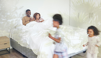 Image showing Relax, family and children being playful in the bedroom while their parents lay in bed with a cup of coffee. Happy, love and young couple drinking a cappuccino while watching their kids run together.