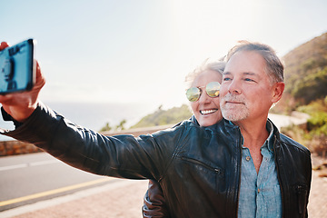 Image showing Senior biker couple, road trip selfie and smile with sunglasses, love and romance on vacation in nature. Elderly lady, happy and travel with old man, profile picture and smile for social network app