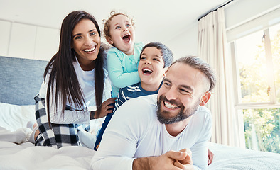 Image showing Portrait, family and laughing on bed in home, having fun and bonding together. Comic, love and care of happy father, mother and kids or boys playing, smile and enjoying quality time in house bedroom.