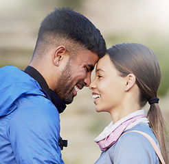 Image showing Man, woman and forehead touch for hiking, love and happiness in nature for outdoor adventure on holiday. Young happy couple, training and smile with care, bonding and vacation in countryside together