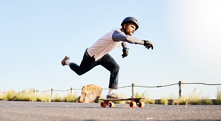 Image showing Skateboard, sports action and man in road for competition, training and exercise challenge in city. Skating, skateboarding and male skater with focus for speed, adventure and freedom in extreme sport