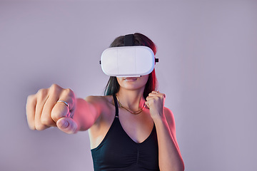 Image showing Vr, fitness and woman boxing in metaverse studio isolated on a purple background mockup. 3d exercise, virtual reality and female fighting or punching with futuristic technology for esports gaming.