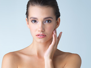 Image showing Skincare, cosmetics and portrait of young woman in studio isolated on blue background in salon makeup. Beauty, portrait of model from Spain and spa facial treatment for fresh clean skin with mockup.