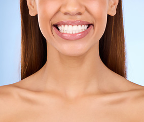 Image showing Dental, teeth and smile of woman in studio for beauty, cleaning and self care. Oral hygiene, natural and cosmetic treatment with girl model isolated on blue background for veneers, fresh or results