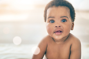 Image showing Portrait, baby and mockup with an african child sitting on a bed in the bedroom of a home for growth or development. Children, face and an adorable black kid looking curious in a house with flare