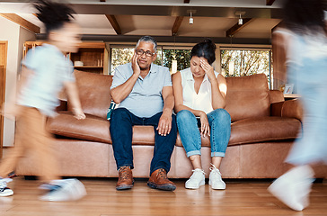 Image showing Kids running, stress and grandparents on couch tired, chaos in living room and frustrated babysitting burnout. Hyperactive children with energy, playing in home with grandma and grandpa with headache