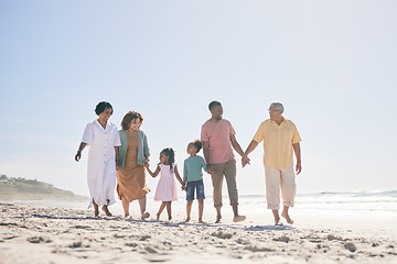 Image showing Grandparents, parents and children walking on beach holding hands for love, support and quality time together. Travel, happy and kids with big family by ocean for holiday, summer vacation and weekend